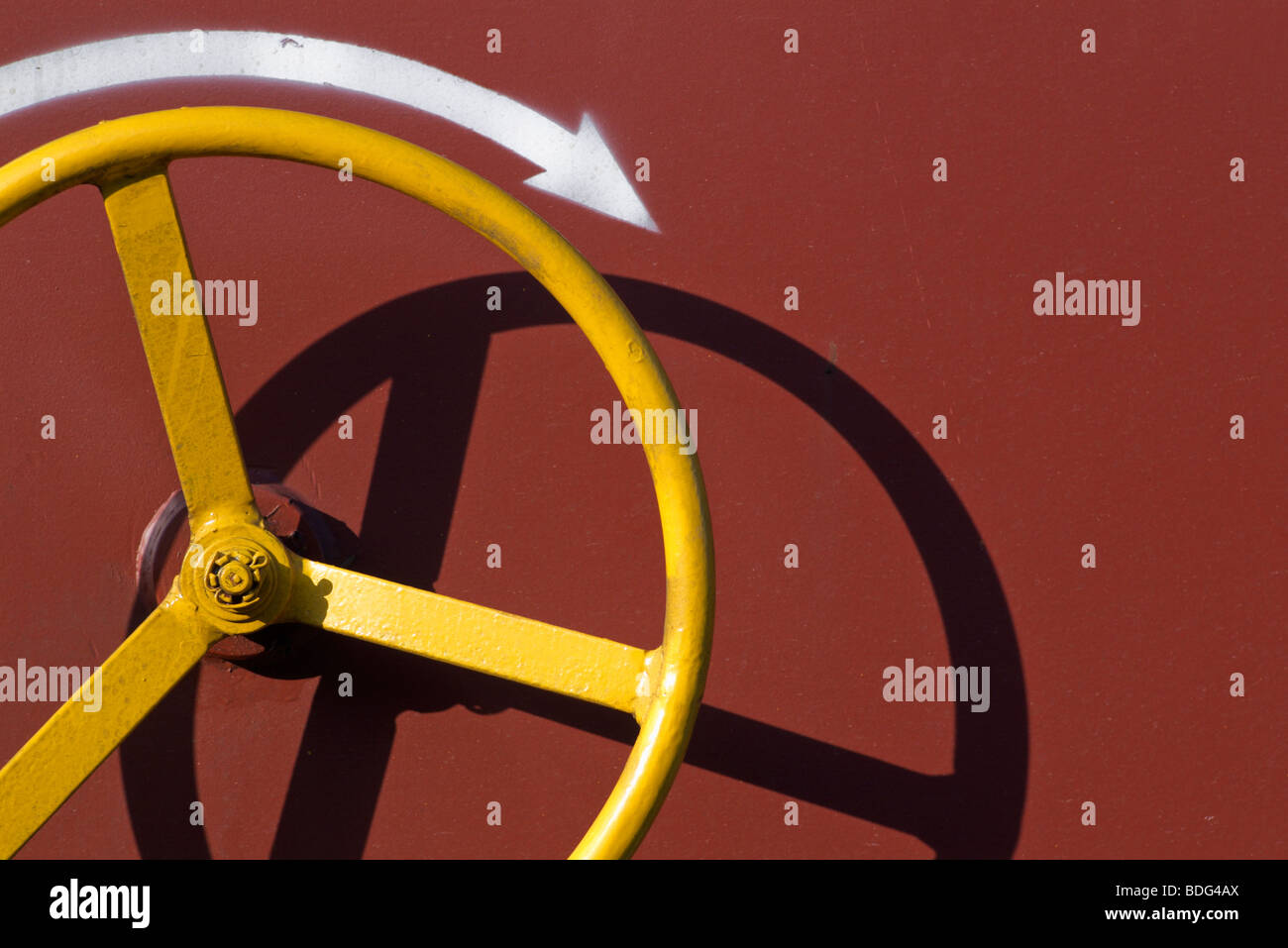 Yellow wheel with shadow with red background Stock Photo - Alamy