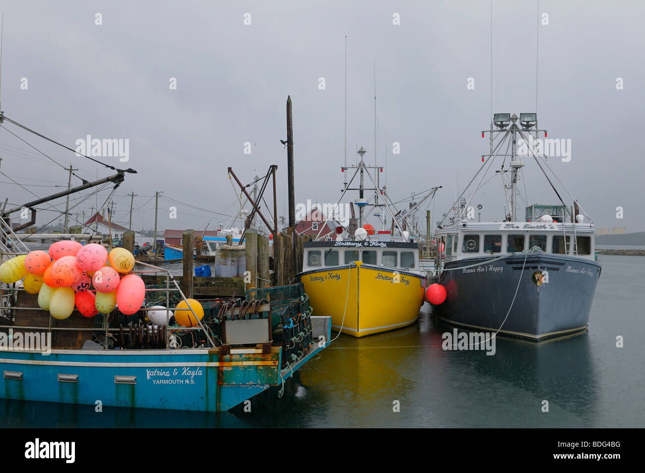 Pouring rain at Johns Cove Yarmouth Bar wharf with lobster boats Stock