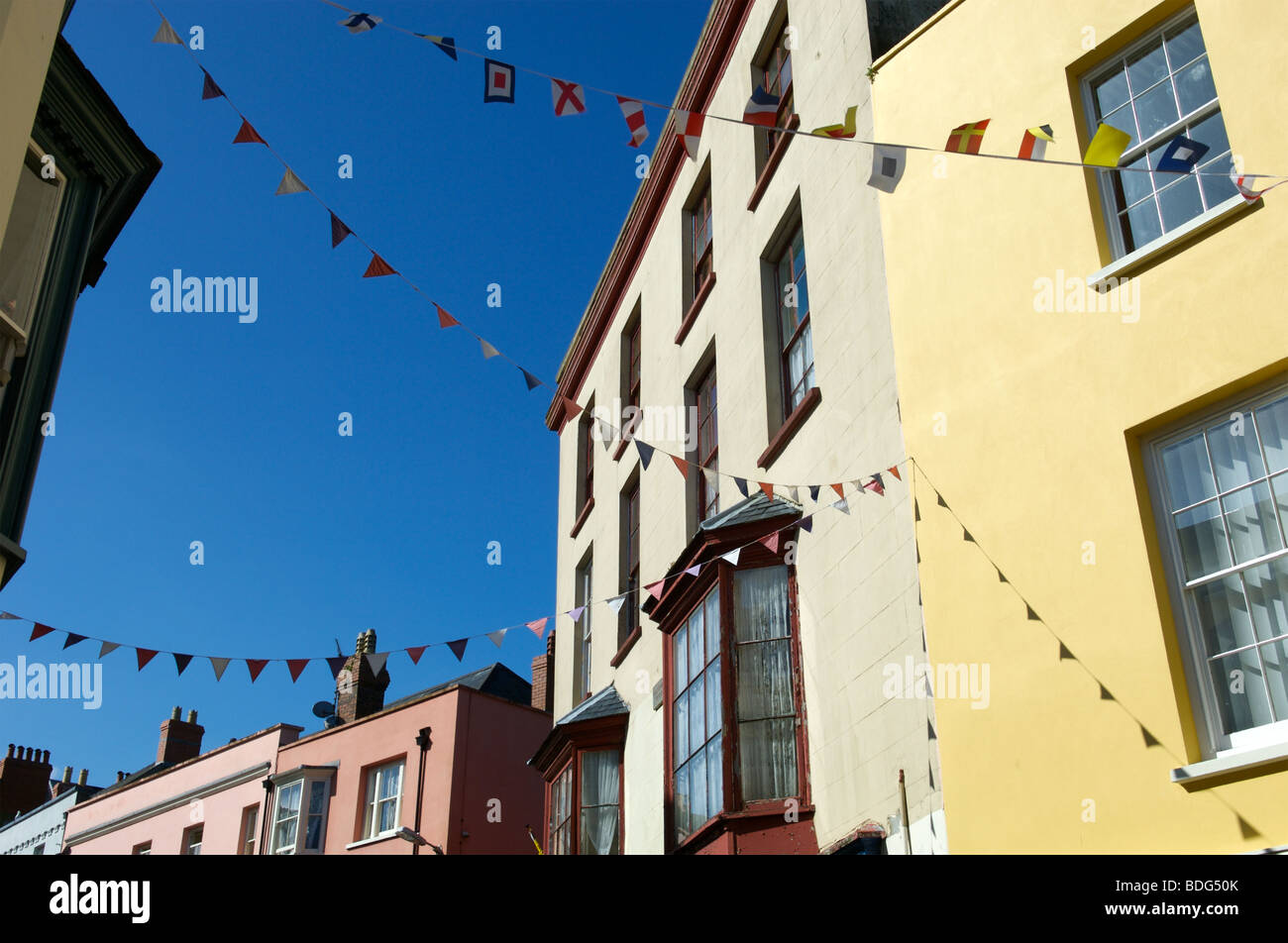A row of colourful houses and bunting in Tenby, Pembrokeshire, Wales. Stock Photo