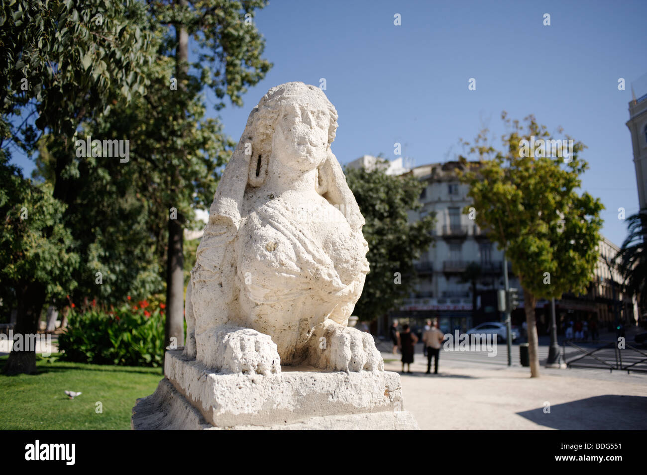 Old worn stone statue on the edge of the Turia park (Jardin del Turia) in the city centre of Valencia. Spain Stock Photo