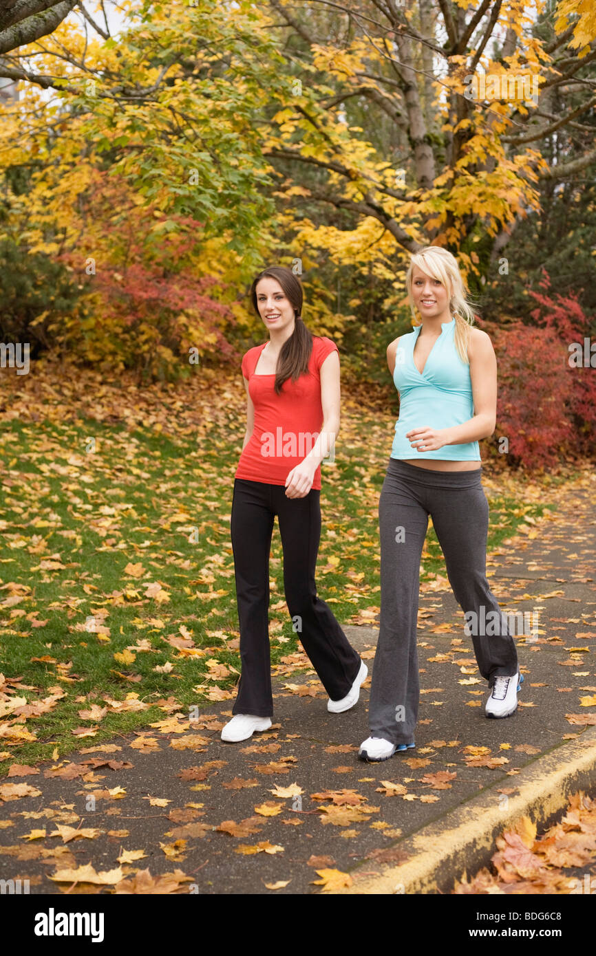 Portrait of two young women walking in fitness attire Stock Photo - Alamy
