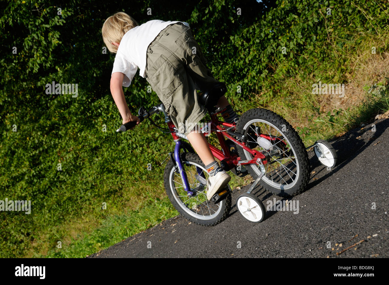 Stock photo of a young boy learning to ride his bike. Stock Photo