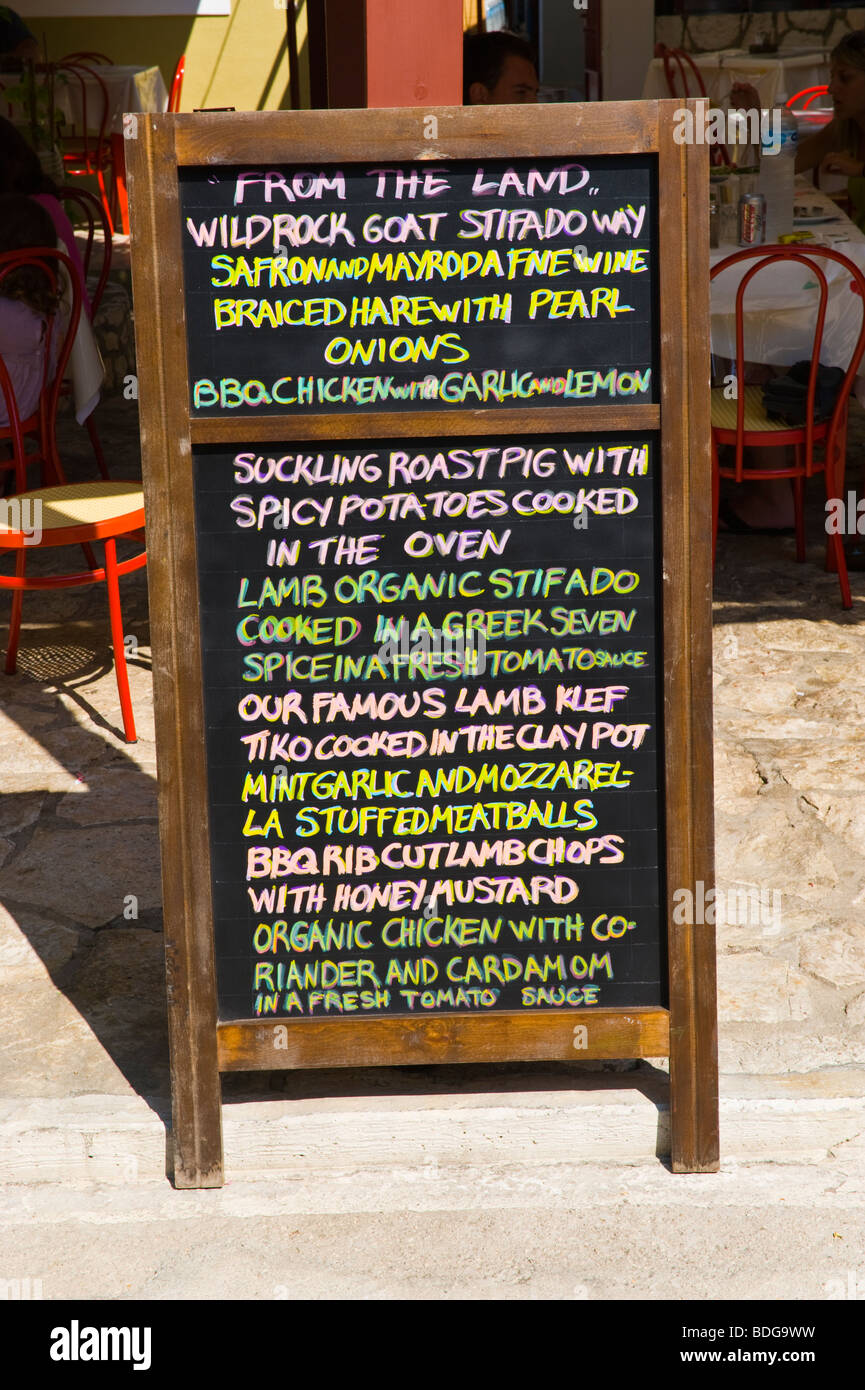 Chalk board menus with daily specials outside restaurant in village of Assos on the Greek island of Kefalonia Greece GR Stock Photo