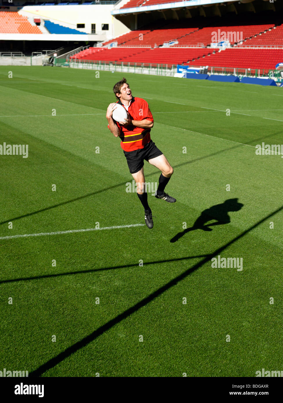 Rugby player catching ball Stock Photo