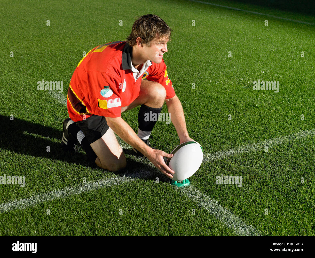 Rugby player placing ball Stock Photo Alamy