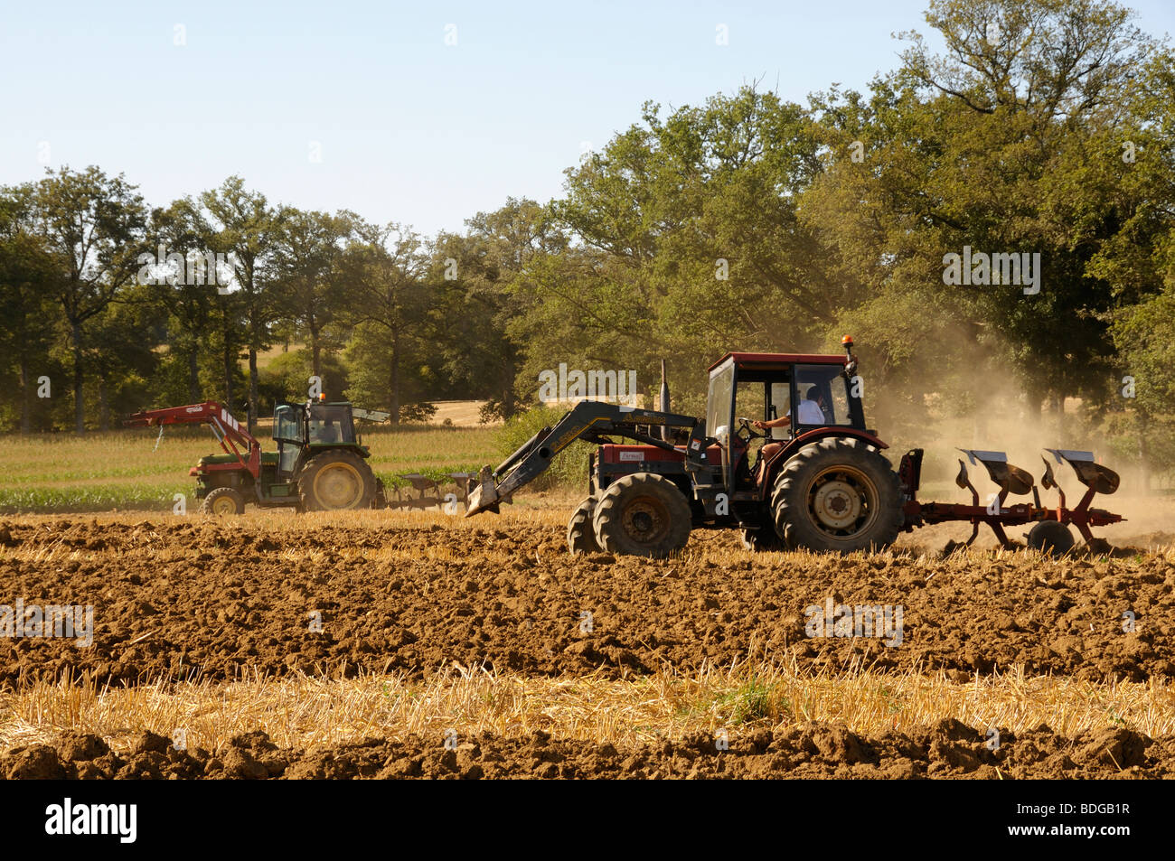 Stock photo of tractors ploughing fields in a farming competition in