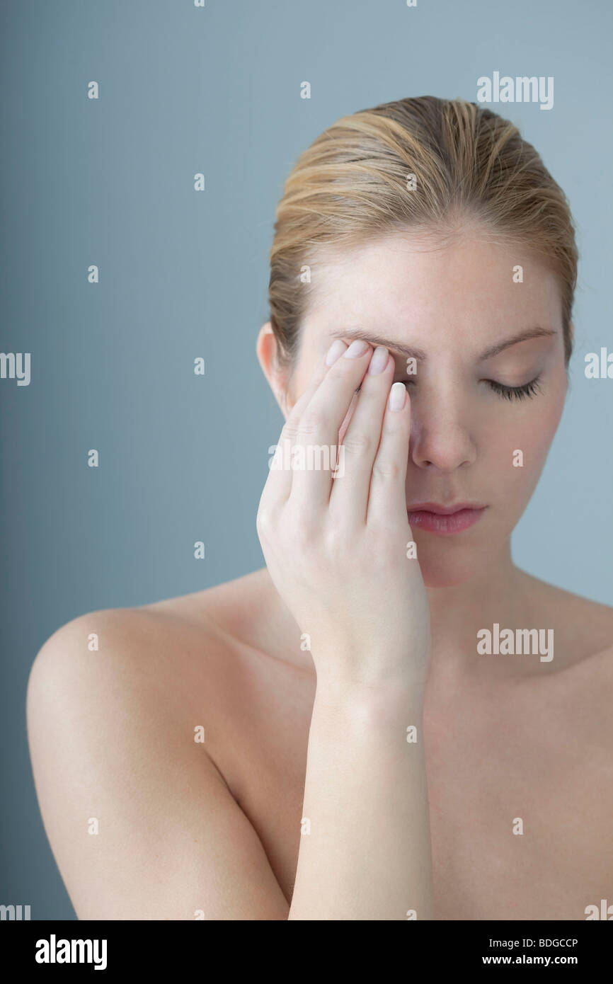 EYE PAIN IN A WOMAN Stock Photo