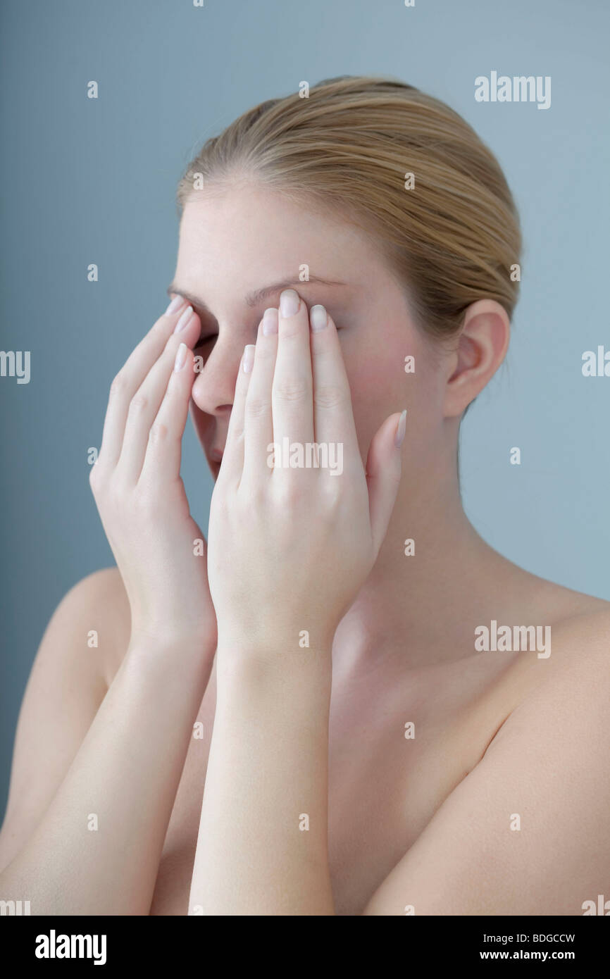 EYE PAIN IN A WOMAN Stock Photo
