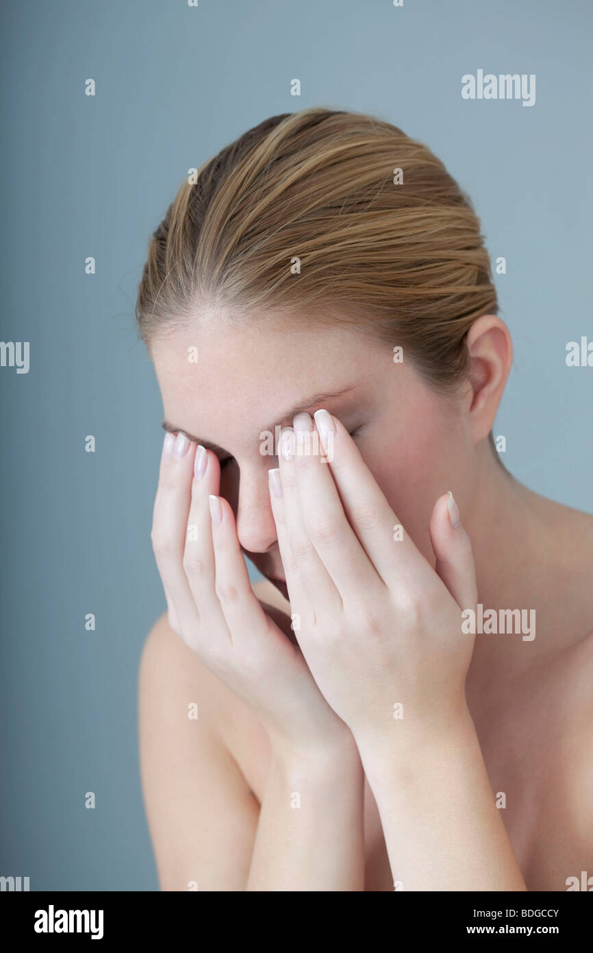 EYE PAIN IN A WOMAN Stock Photo