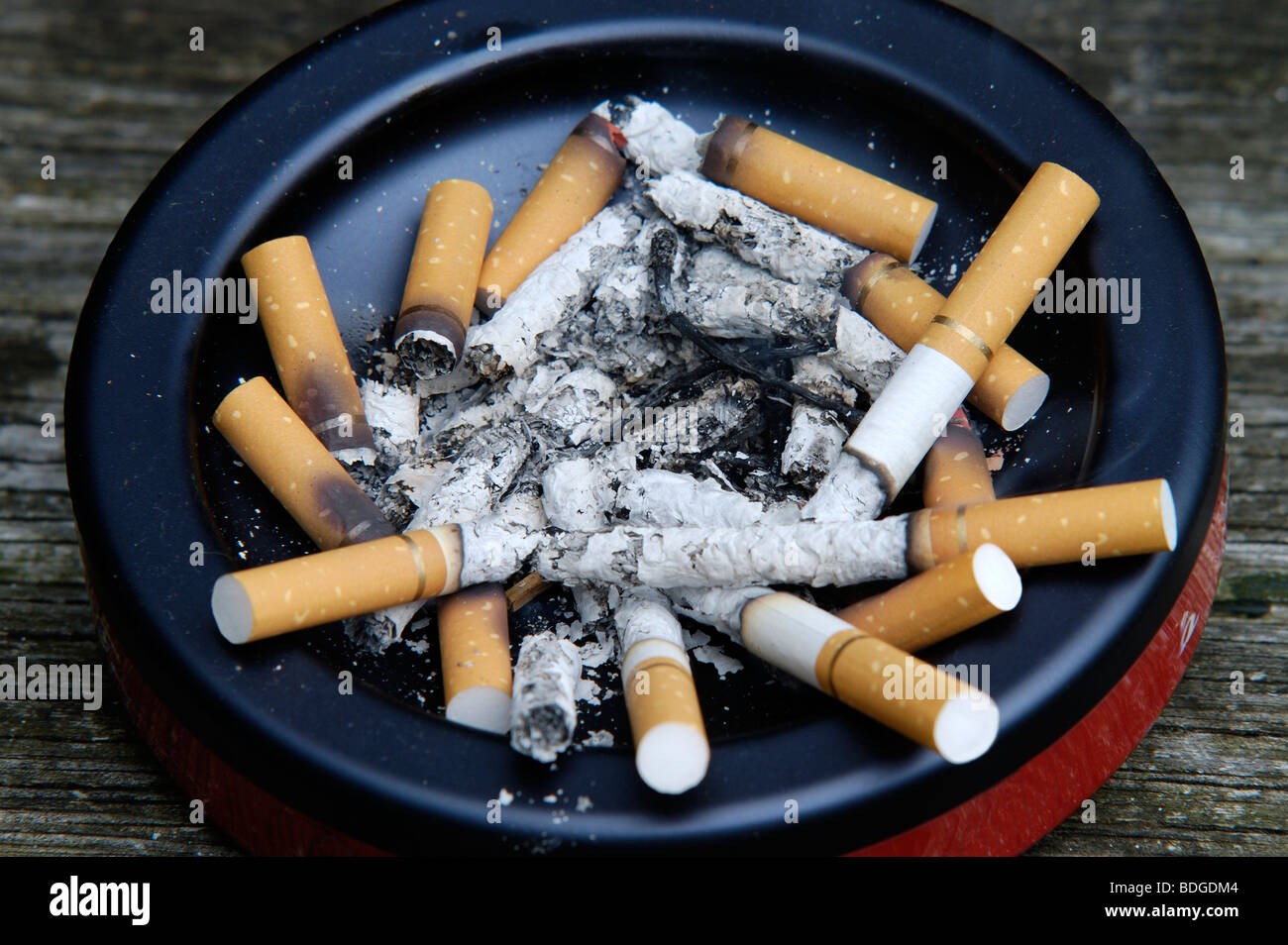 Ashtray full of half smoked cigarettes, ash and butts Stock Photo Alamy