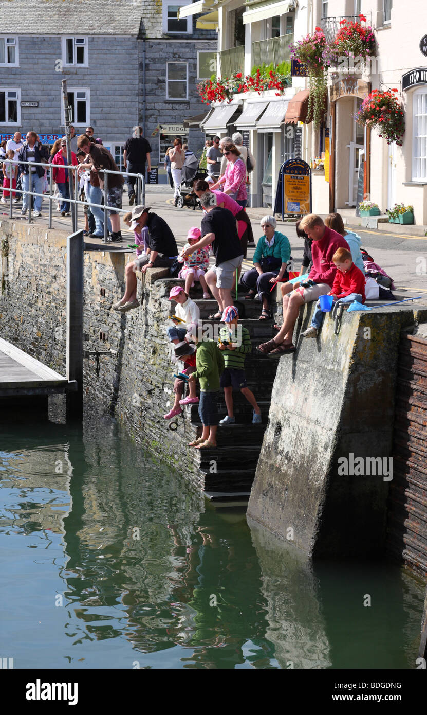 Children crab fishing at Padstow Harbour, Padstow, North Cornwall, England, U.K. Stock Photo