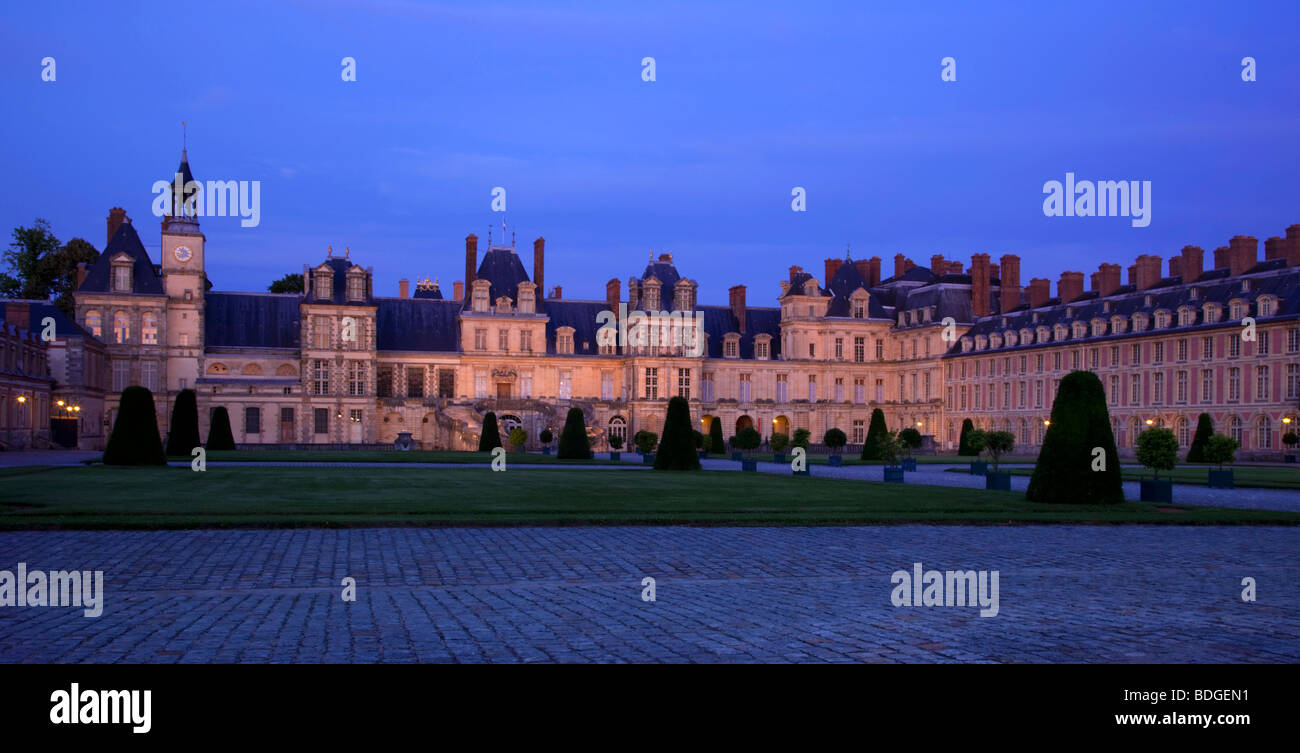 Fontainebleau chateau west elevation whitehorse courtyard at night , Paris, France Stock Photo