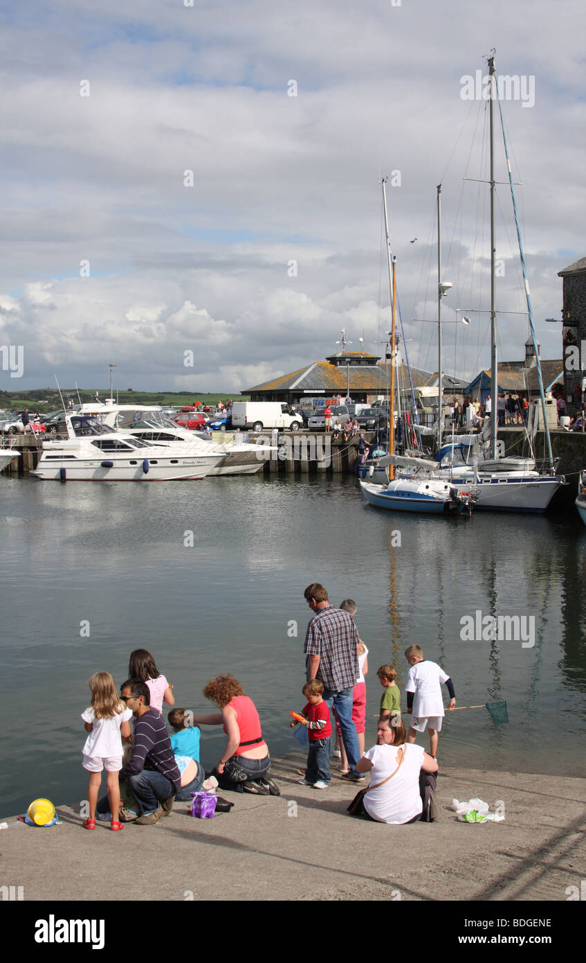 Families crab fishing at Padstow Harbour, Padstow, North Cornwall, England, U.K. Stock Photo
