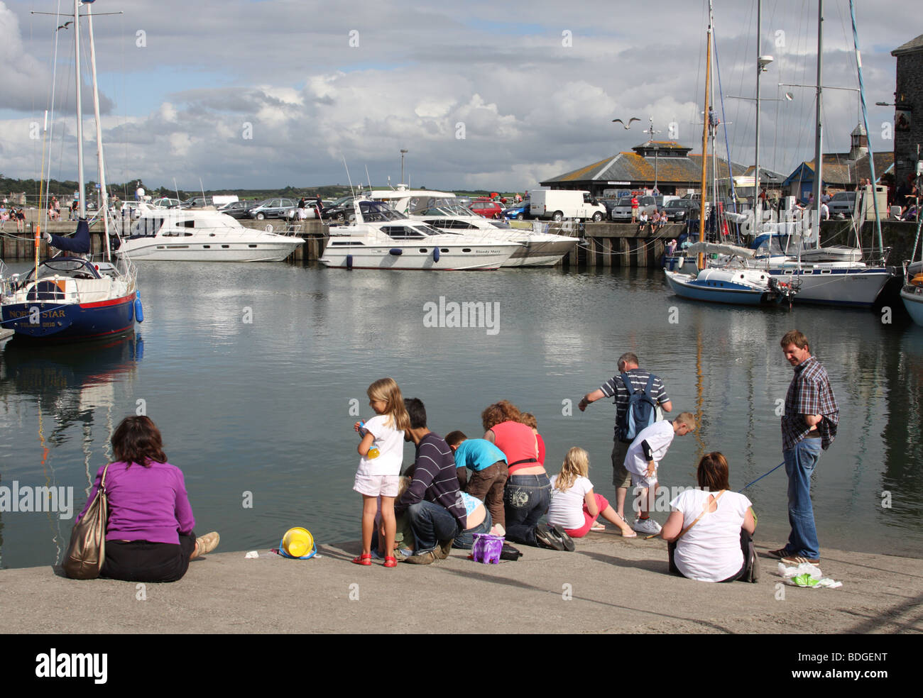 Families crab fishing at Padstow Harbour, Padstow, North Cornwall, England, U.K. Stock Photo