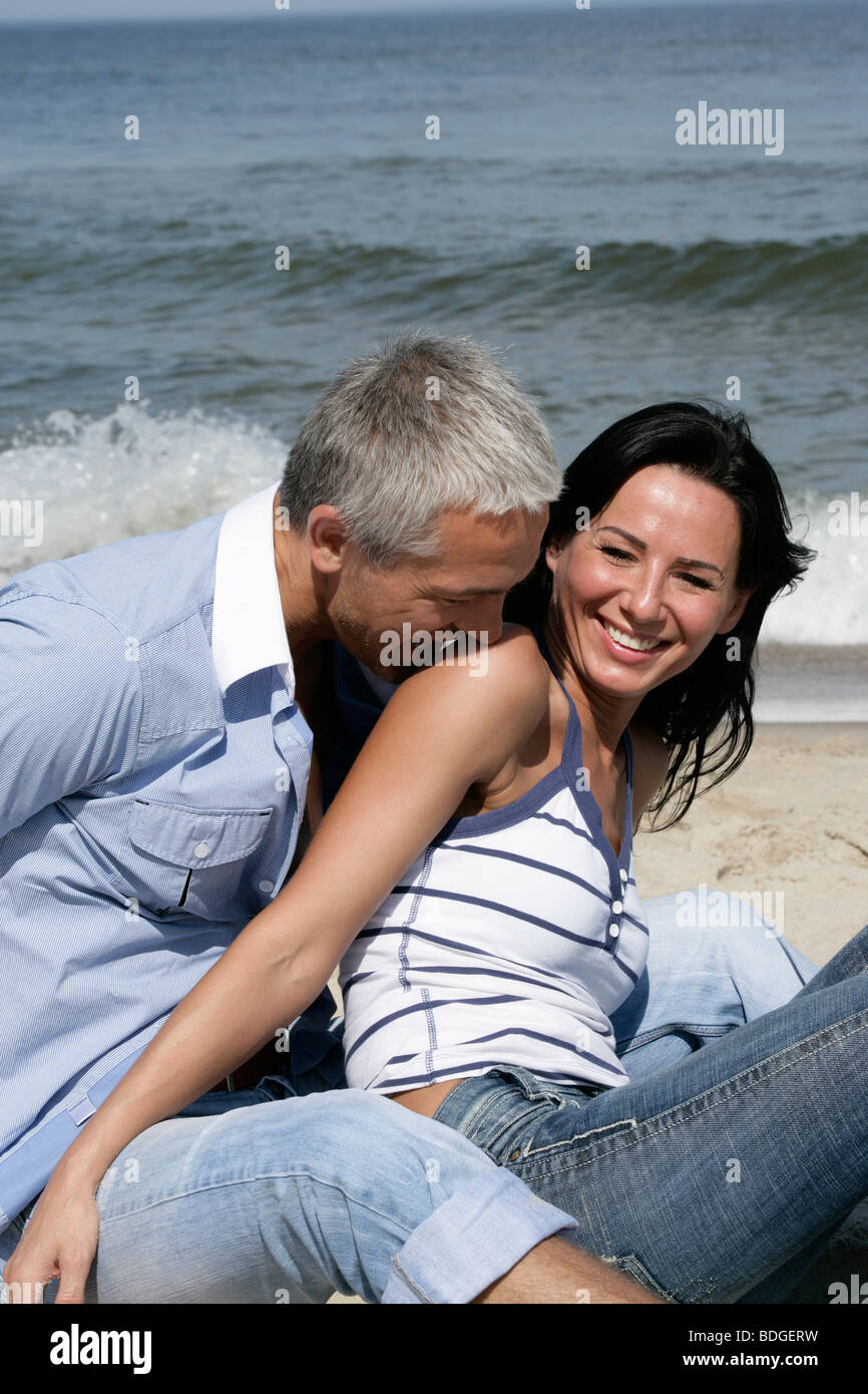 Mature Couple Having Fun On The Beach Enjoying Their Time Together
