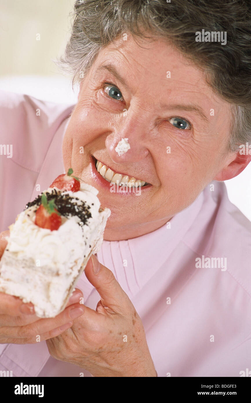 ELDERLY PERSON EATING SWEETS Stock Photo Alamy