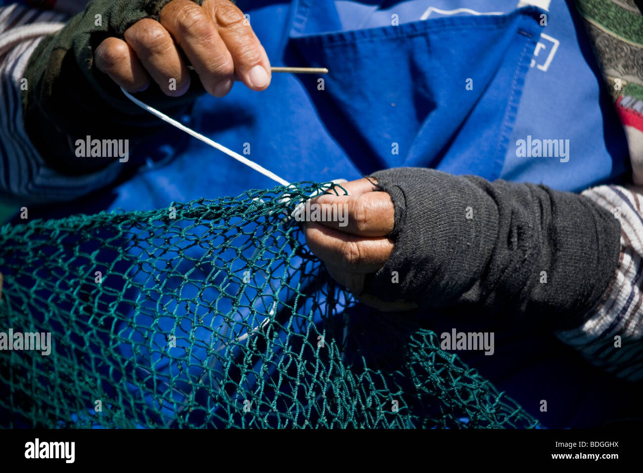 Woman mending fishing nets, St Helena Bay, Cape, South Africa Stock