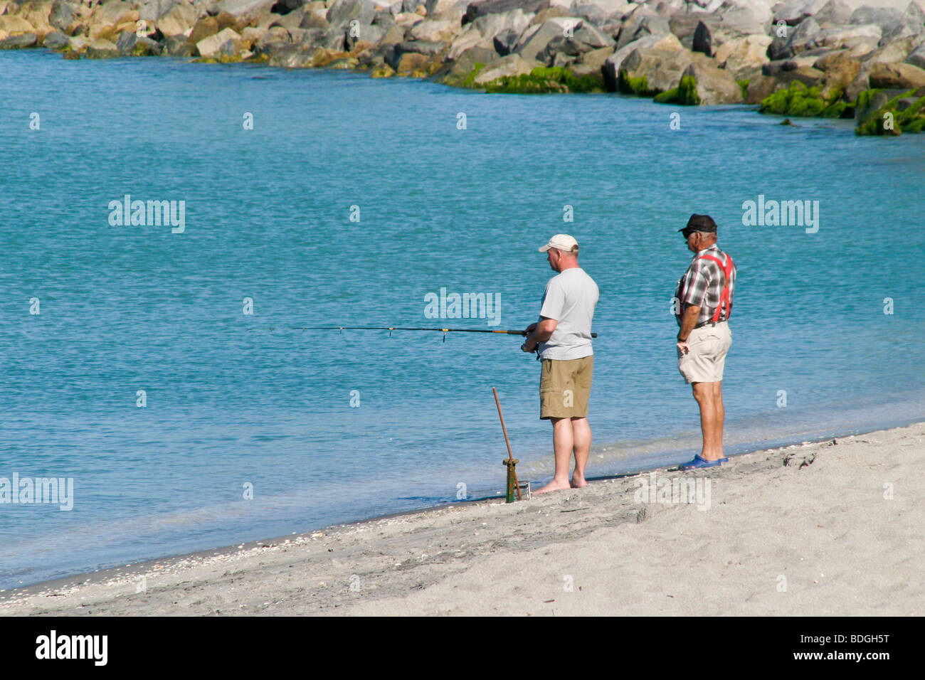 Two men unloading fishing poles and equipment from bed of a red pickup truck  parked at the boat ramp and dock near Yankeetown Stock Photo - Alamy