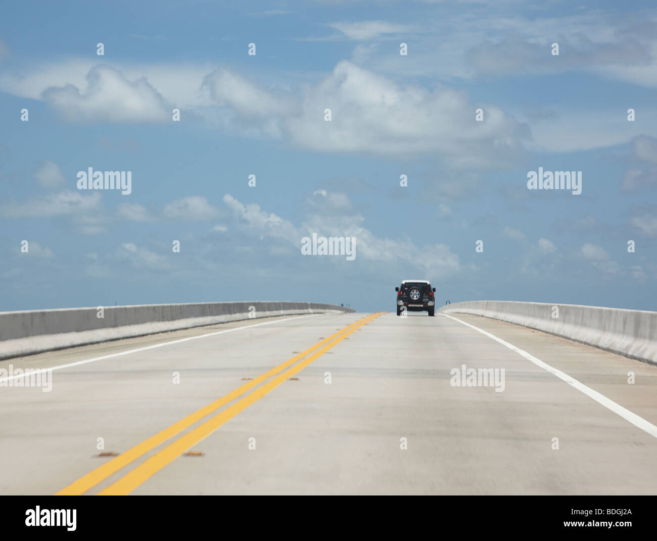 car driving over a bridge Stock Photo