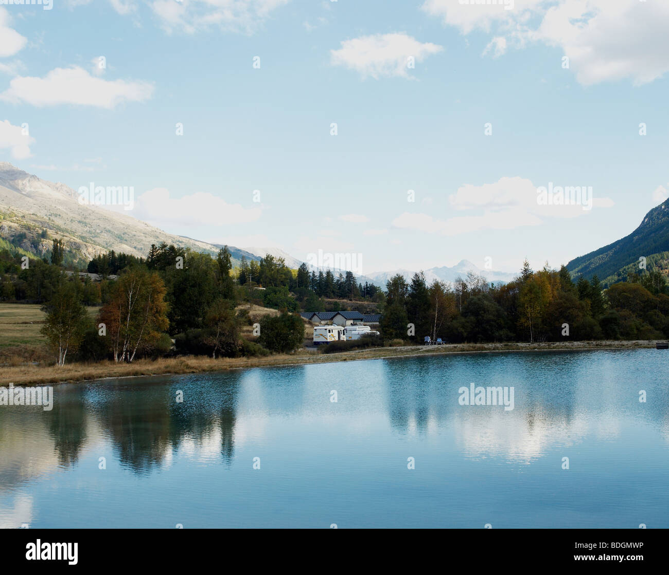 reflection of an Alpine mountain peak in a lake. Stock Photo