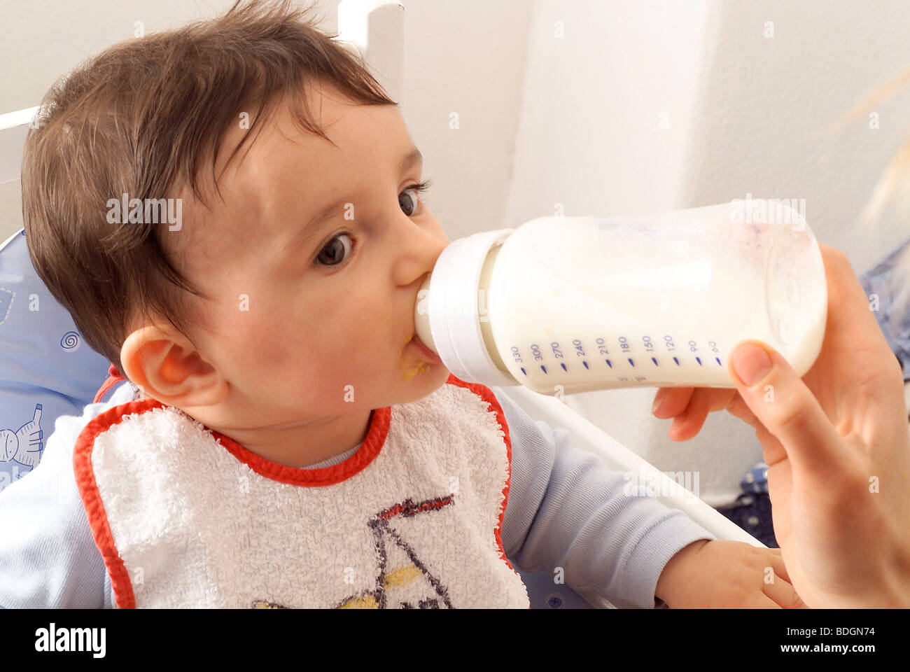 INFANT DRINKING FROM BABY BOTTLE Stock Photo Alamy