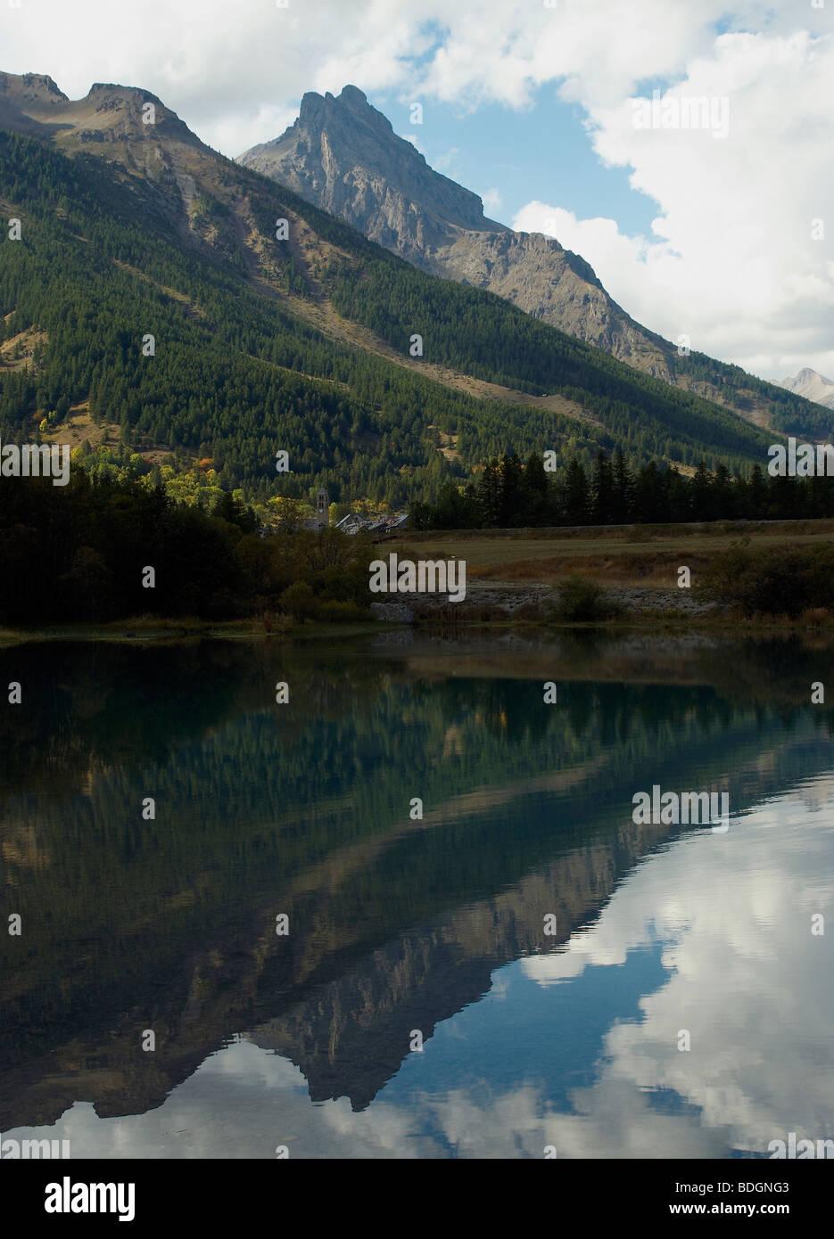 reflection of an Alpine mountain peak in a lake. Stock Photo