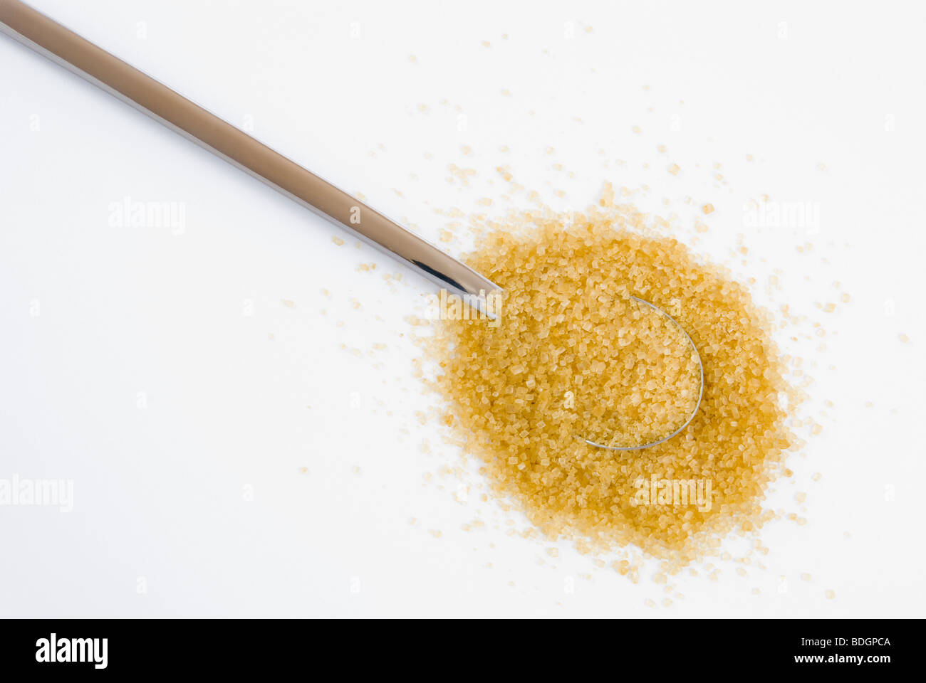 Brown sugar on silver teaspoon arranged on white background Stock Photo
