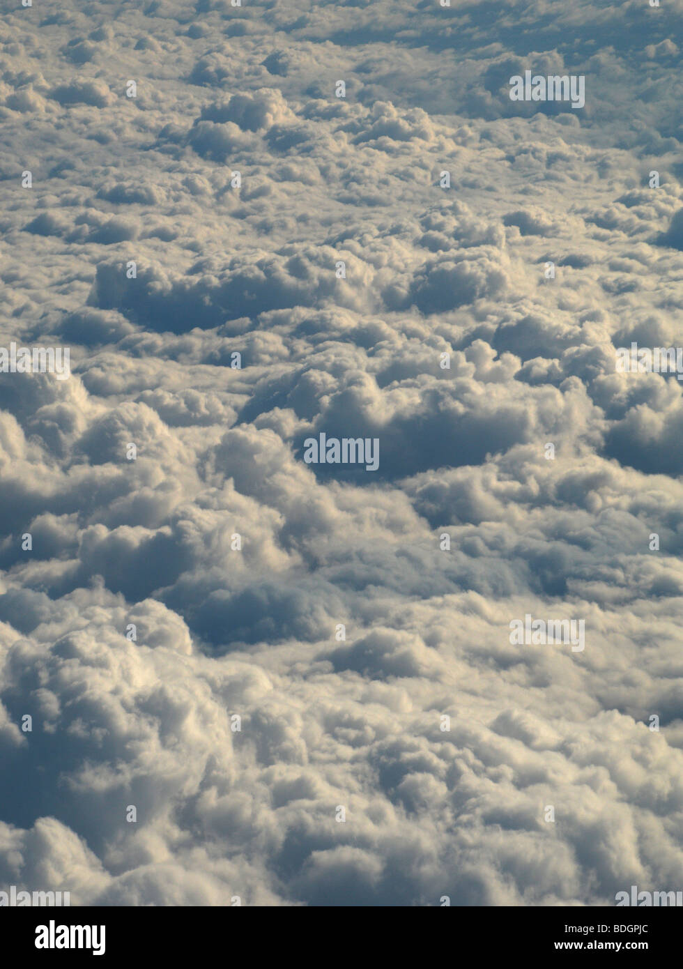 Early morning sunlight hitting a blanket of clouds shot from above Stock Photo