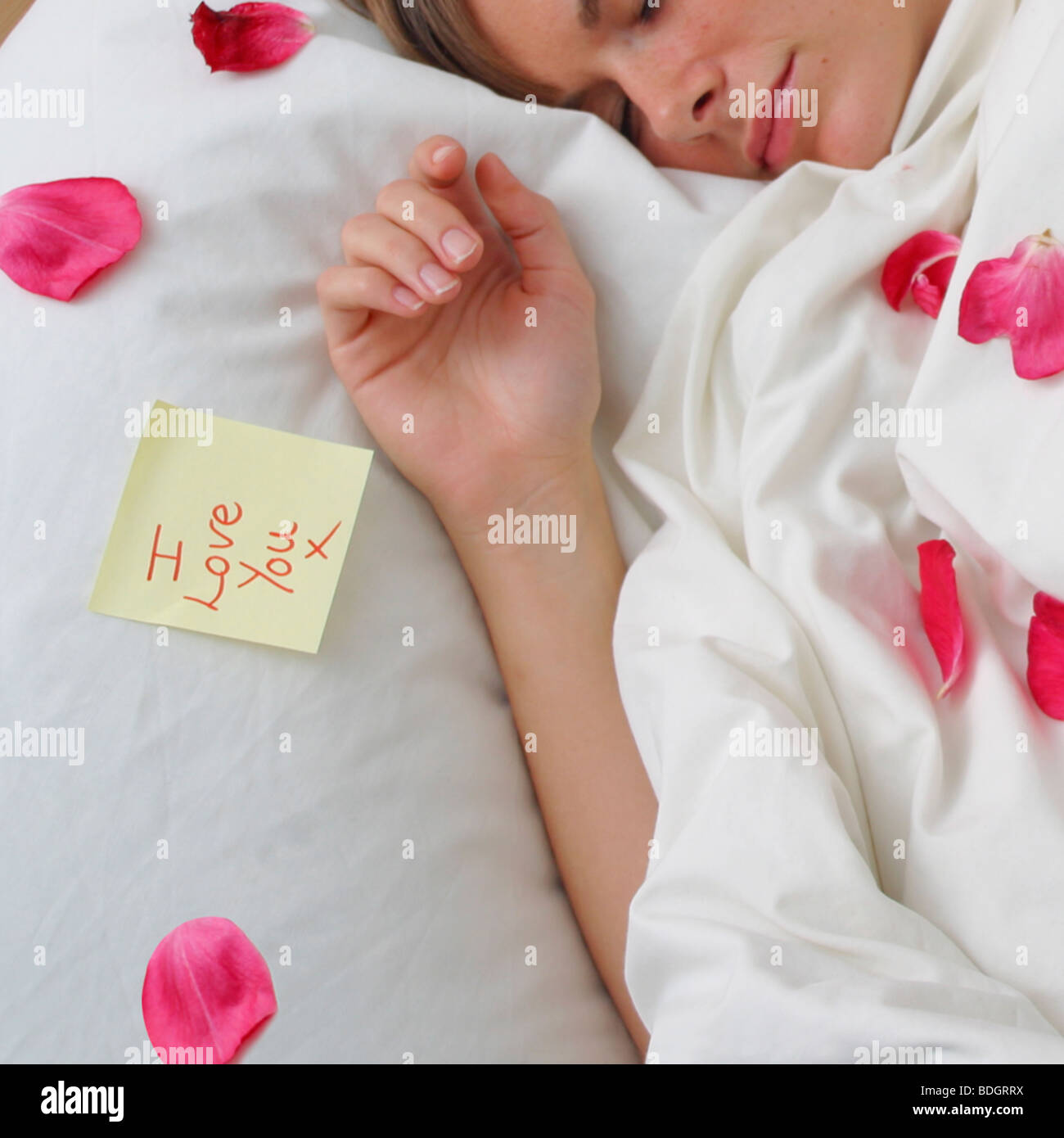 Girl Woman Sleeping With Pink Rose Petals Scattered Onto Pillow