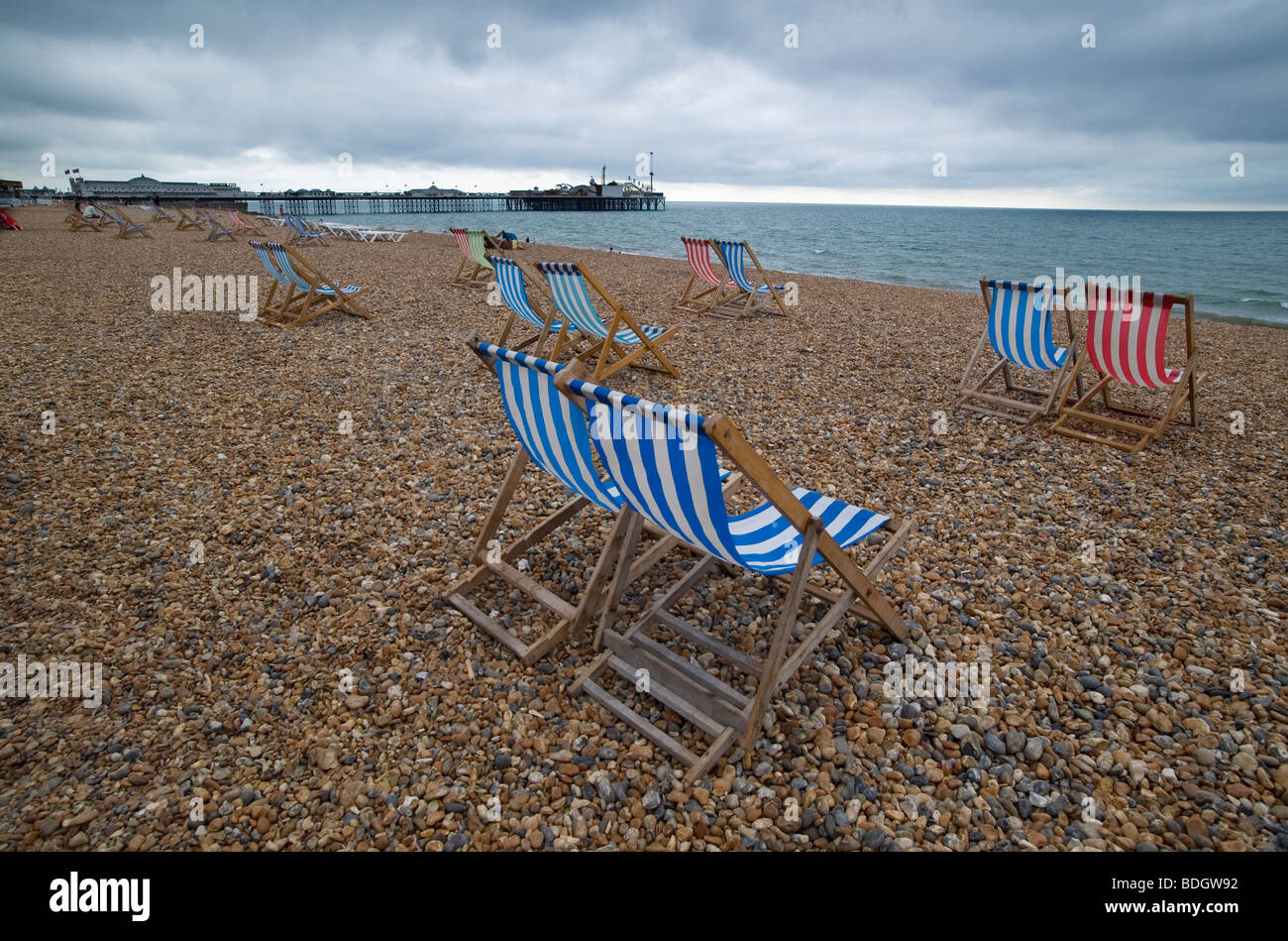 Brighton Britain England Holiday Staycation happy enjoy Summer Sunshine Hot beach Blue sky August deck chairs blue red stripes Stock Photo