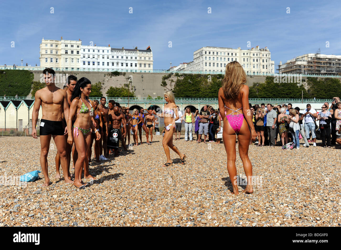 Contestants in the Fame UK bodybuilding championships pose for photographers on the beach at Brighton Sussex UK Stock Photo