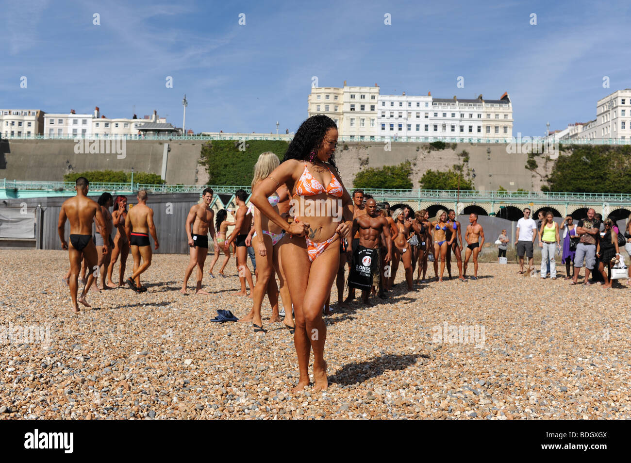 Contestants in the Fame UK bodybuilding championships pose for photographers on the beach at Brighton Sussex UK Stock Photo