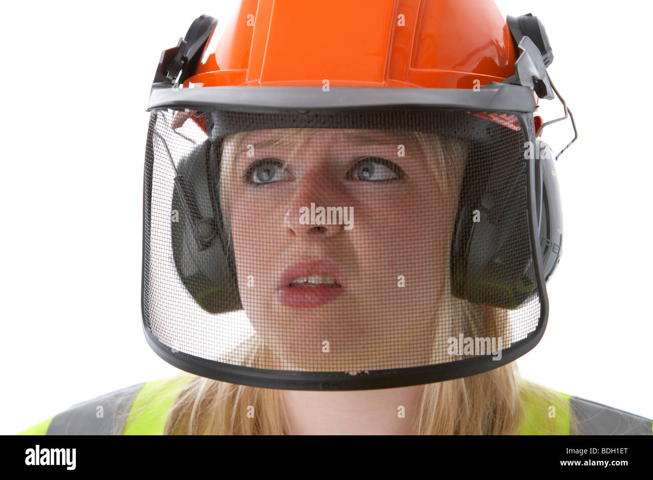 young 20 year old blonde woman wearing orange hard hat ear protectors visor and high vis vest Stock Photo