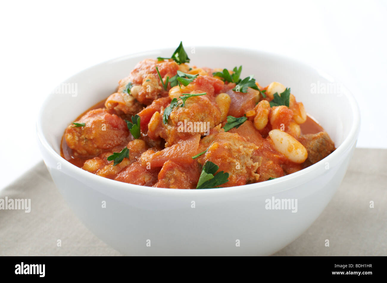 Duck and pork sausage cassoulet, with cannellini and flageolet beans garnished with parsley Stock Photo