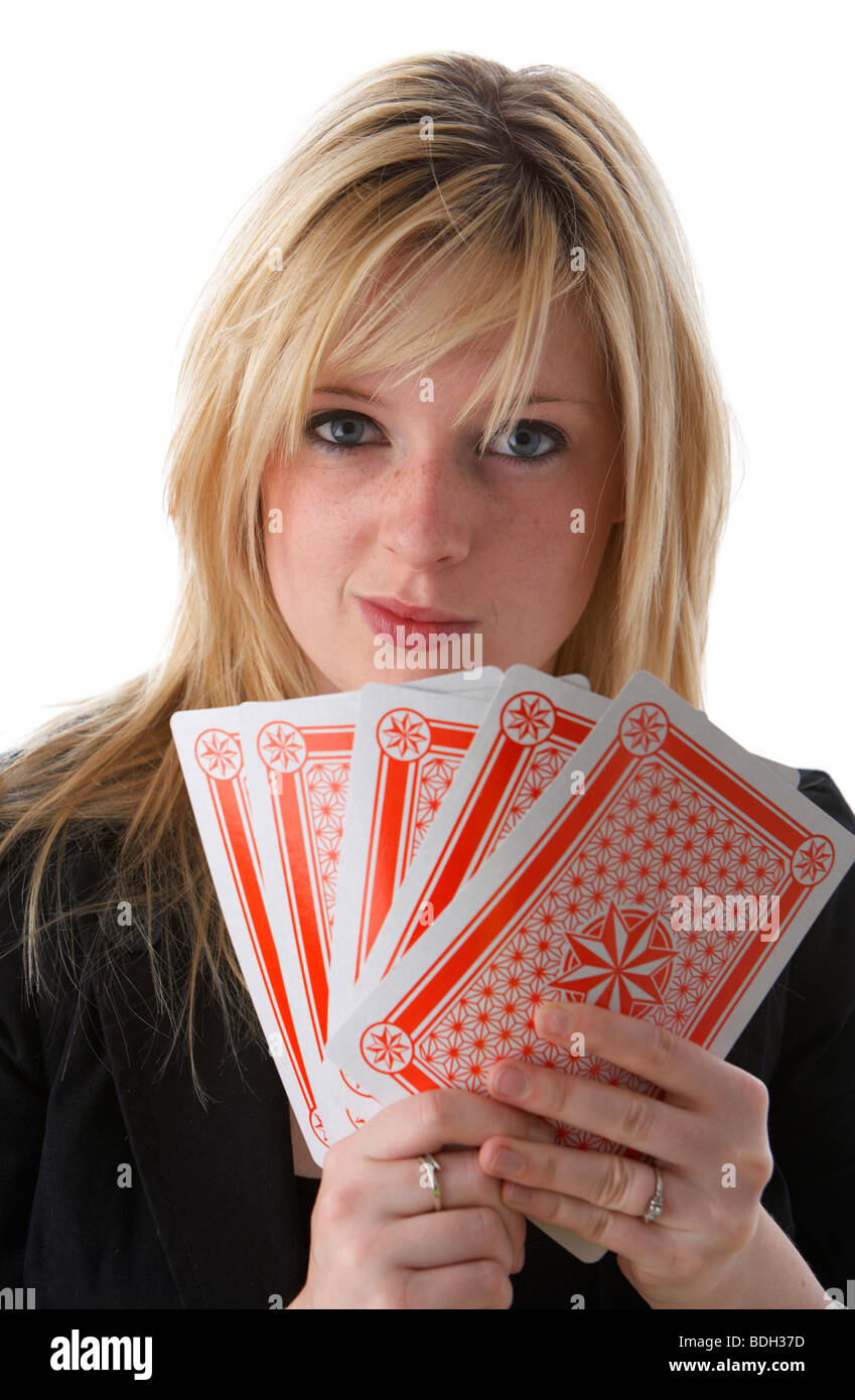 young 20 year old blonde woman holding five large playing cards with wry smile Stock Photo