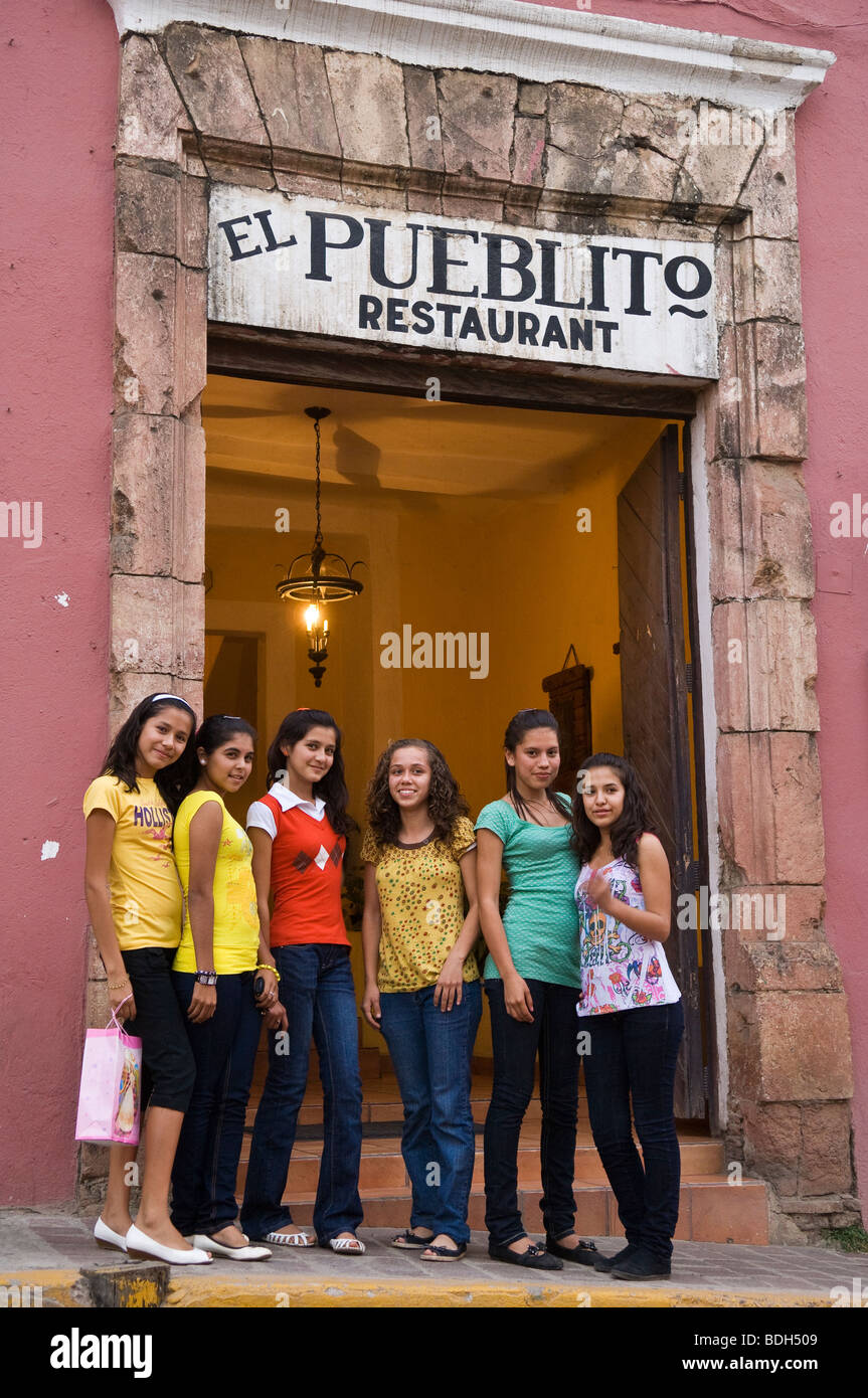 Local teenage girls in front of El Pueblito Restaurant in the town of Cosala in Sinaloa, Mexico. Stock Photo