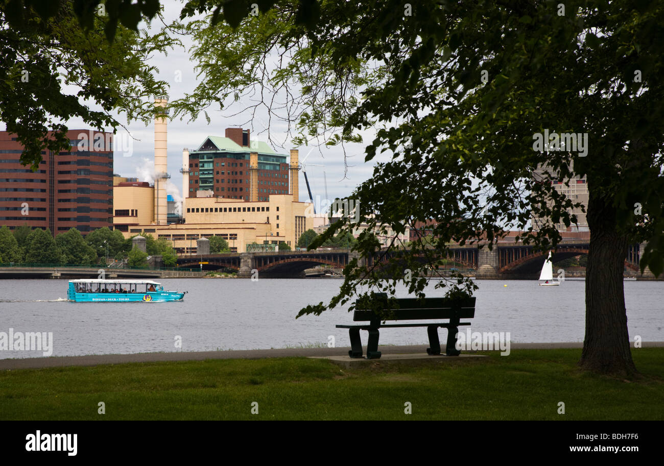 A bench and tour boat in the CHARLES RIVER PARK - BOSTON, MASSACHUSETTS Stock Photo