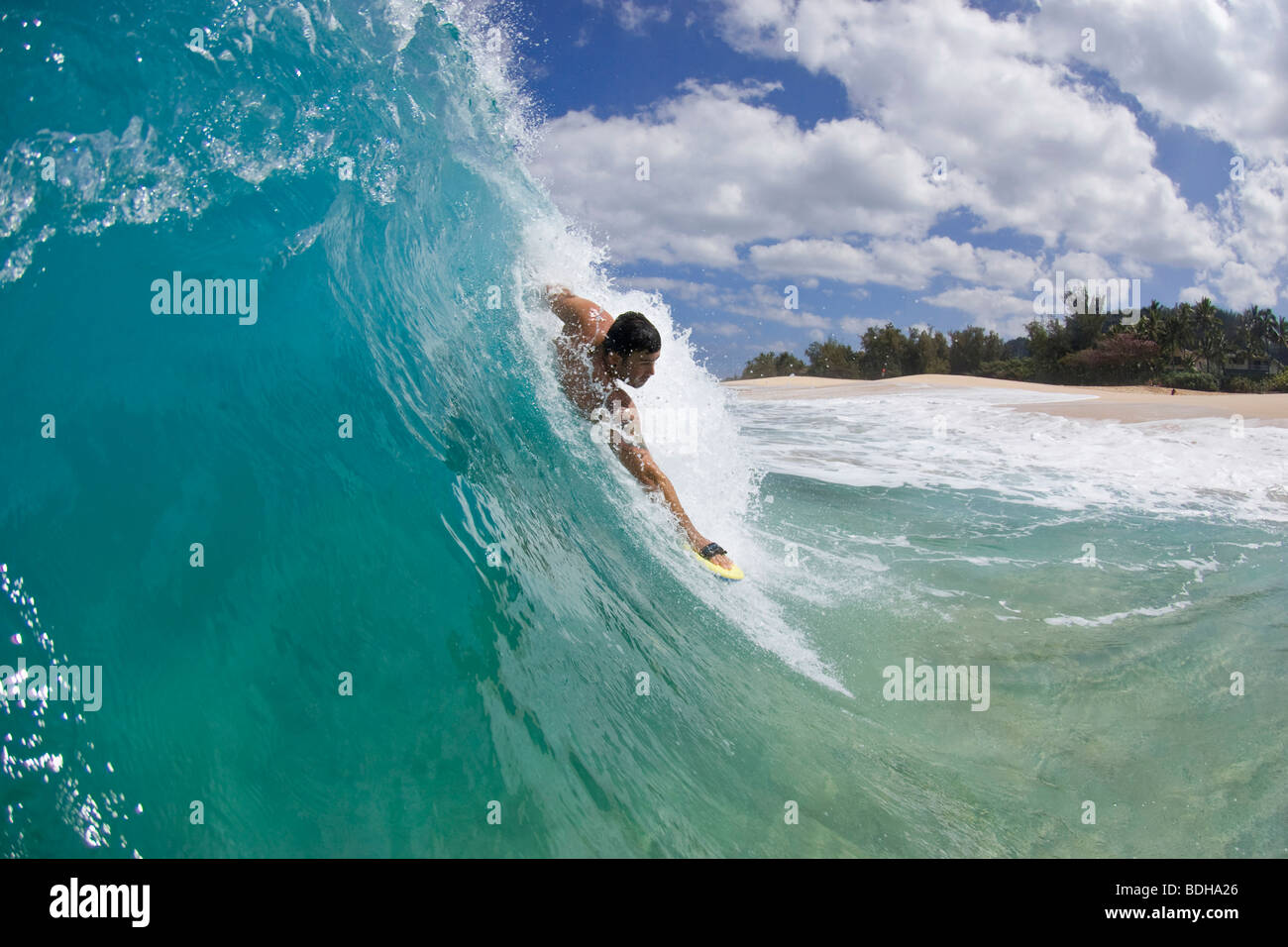 A young man body surfing at Keiki Beach on the North Shore of Oahu, Hawaii. Stock Photo