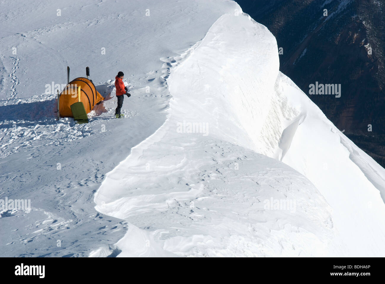 A man camping on a high ridge line in the winter, San Juan National Forest, Colorado. Stock Photo