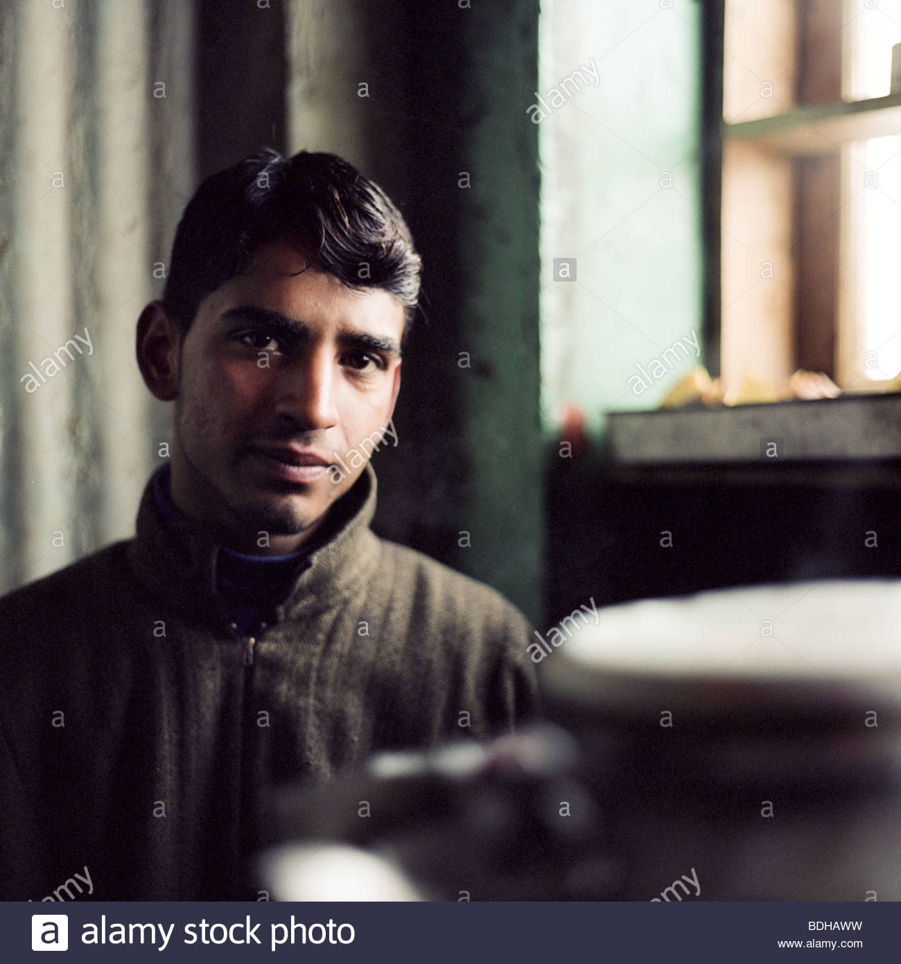 A young Kashmiri man poses in a tea shop in Gulmarg, Kashmir