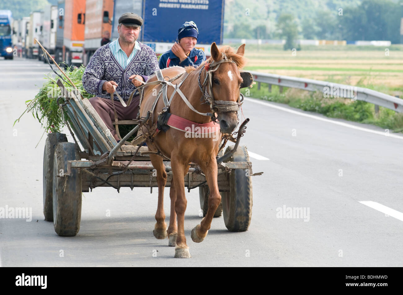 horse and wagon at Bulgarian-Romanian border, trucks waiting at border to cross river Stock Photo