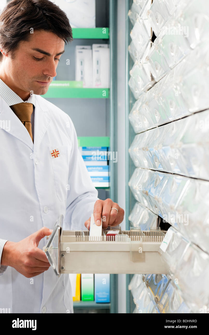 pharmacist taking medicine from drawer. Copy space Stock Photo