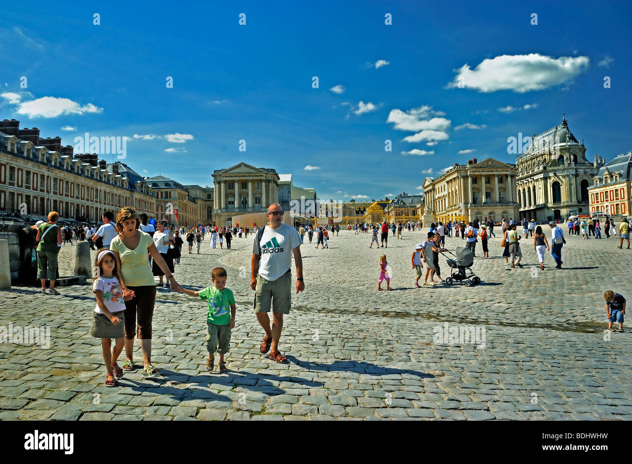 Versailles Palace - Tourist Family Visiting French Monument, 'Chateau de Versailles', Walking in Courtyard, front of French chateau, historic holidays Stock Photo