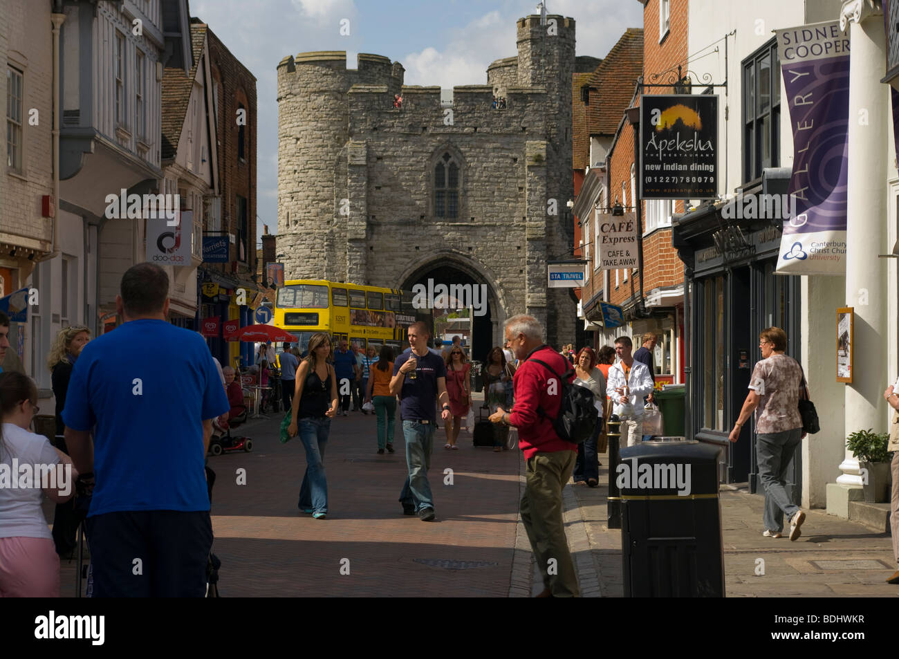 The High Street Canterbury Kent England uk Busy With Shoppers With The Historical West Gate In The Distance Stock Photo