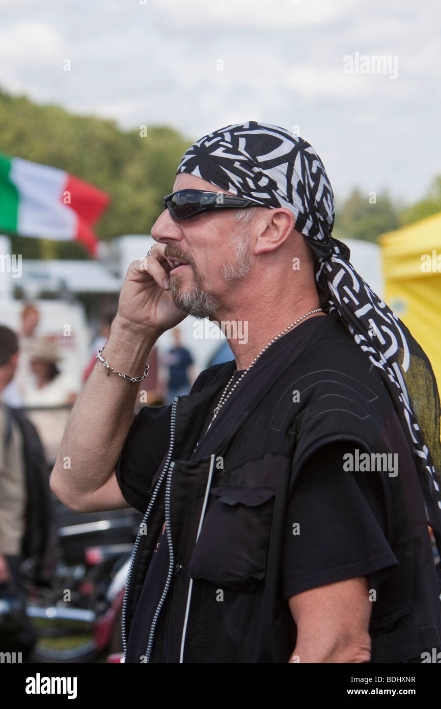 Biker using mobile phone Stock Photo