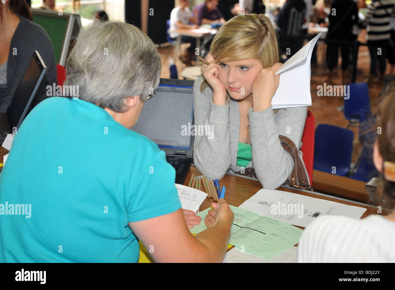 A school girl listening to an advisor after receiving her GCSE results Stock Photo