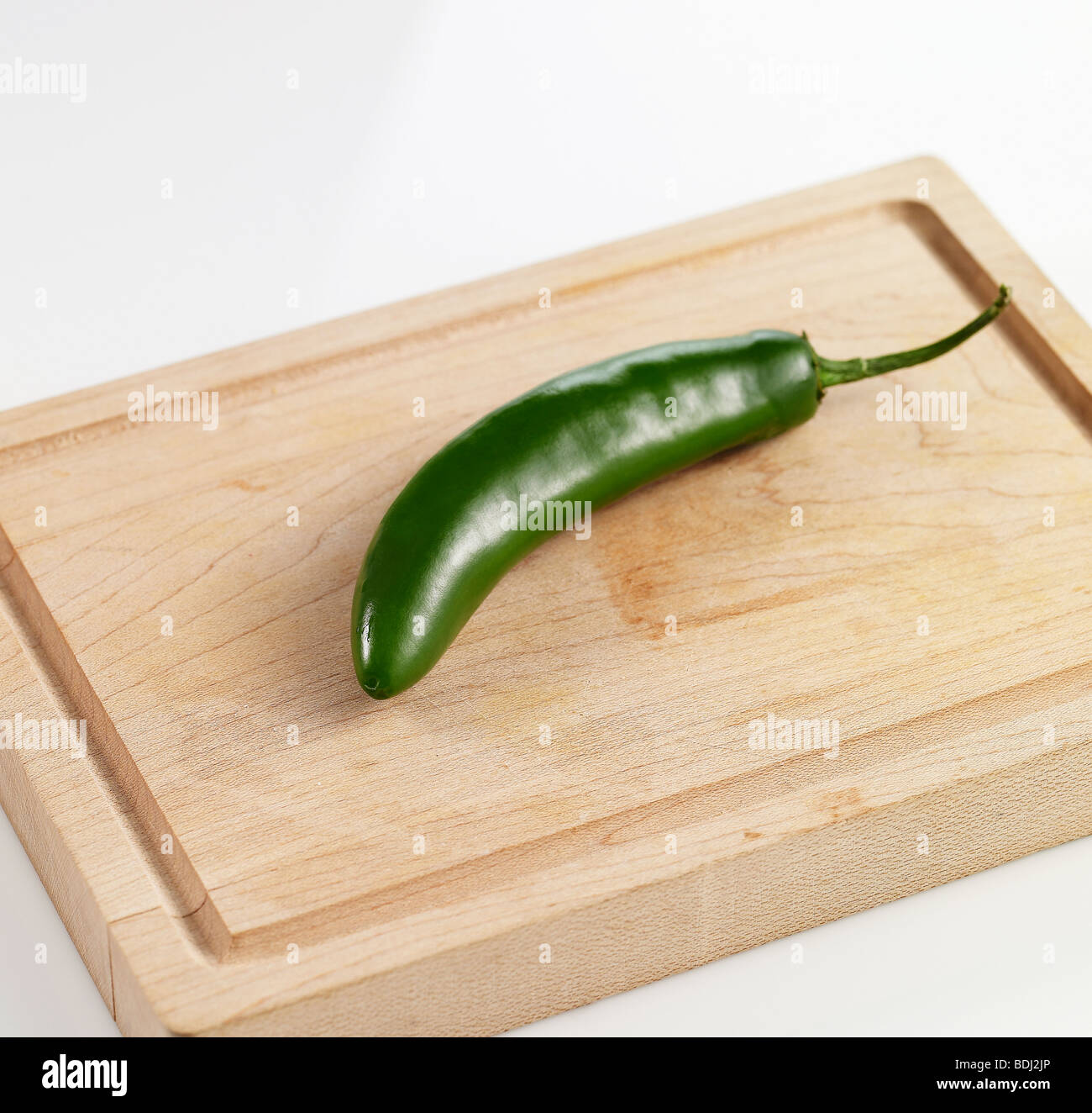 Serrano pepper on a wodden cuttingboard Stock Photo