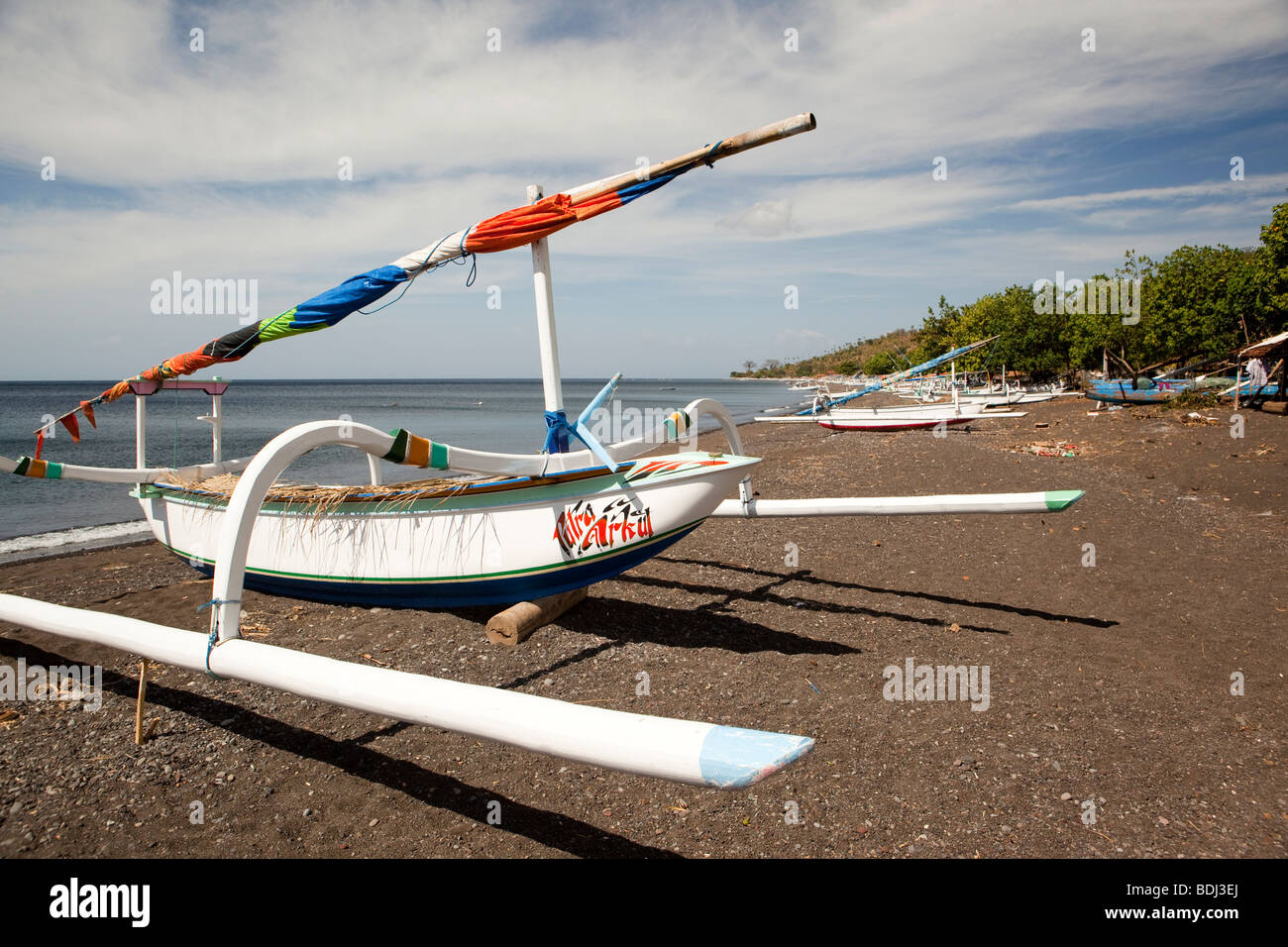 Indonesia, Bali, Amed, colourfully painted outrigger fishing boats on the black volcanic sand beach Stock Photo