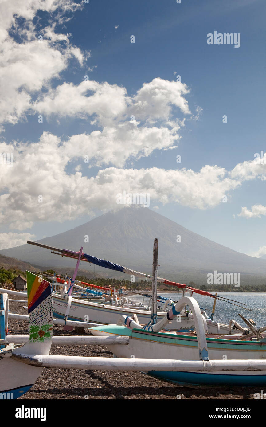 Indonesia, Bali, Amed, colourfully painted outrigger fishing boats below Gunung Agung Stock Photo