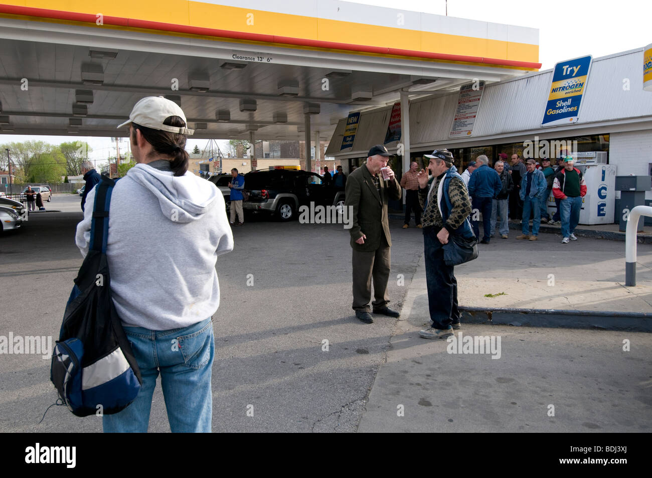 Day labourers waiting to get job at chicago petrol station Stock Photo